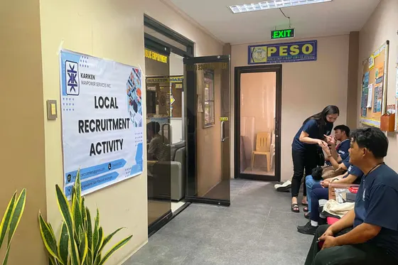 Local recruitment activity desk with applicants waiting